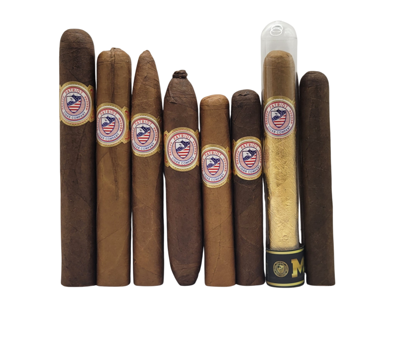 The Premium Sampler Pack features nine cigars of different sizes and shades, each with a patriotic badge label. One cigar is displayed in a clear tube with a gold wrapper, all arranged against a white background.